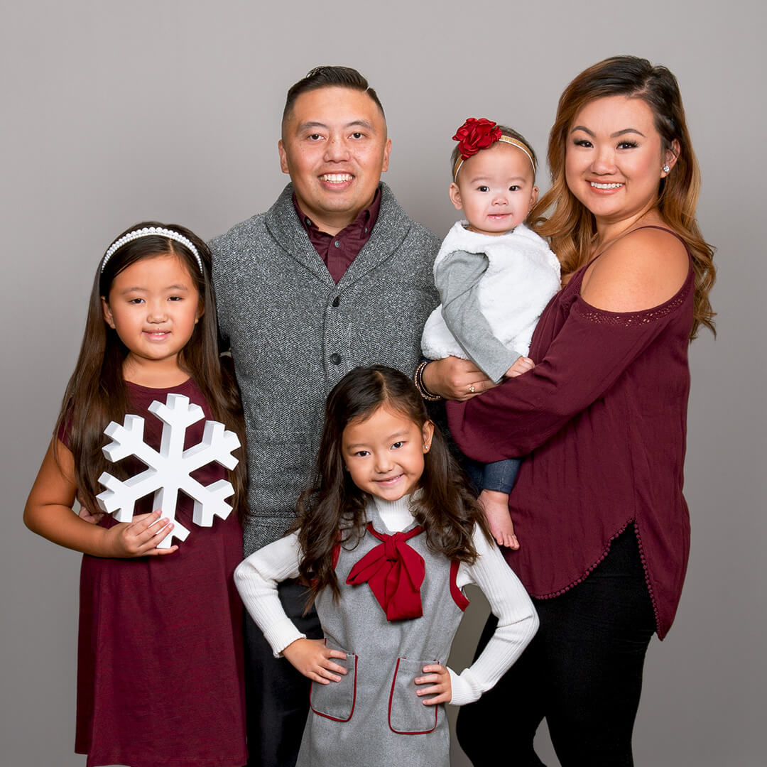 Family photographed on Holiday Classic background