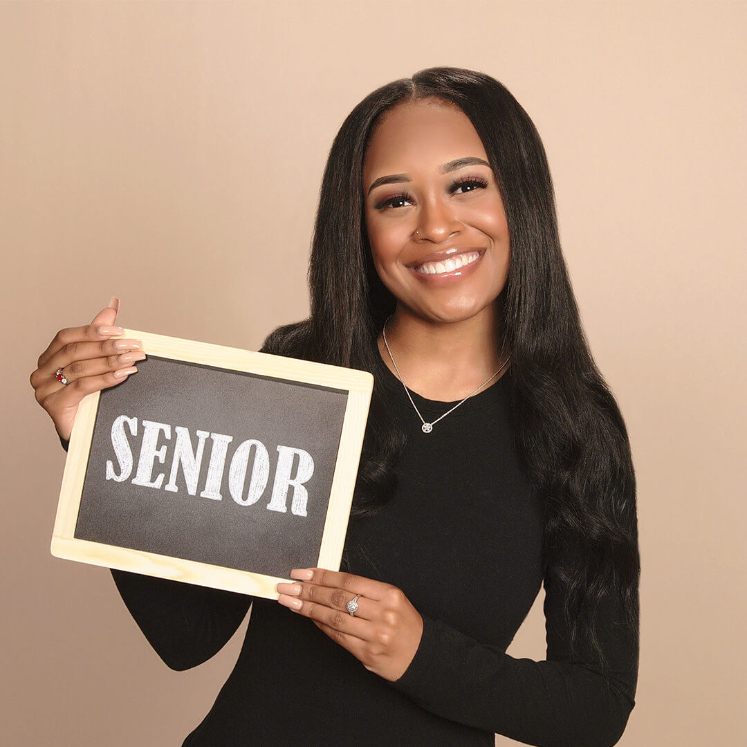 High school senior posing for senior photos at JCPenney Portrait Studios.