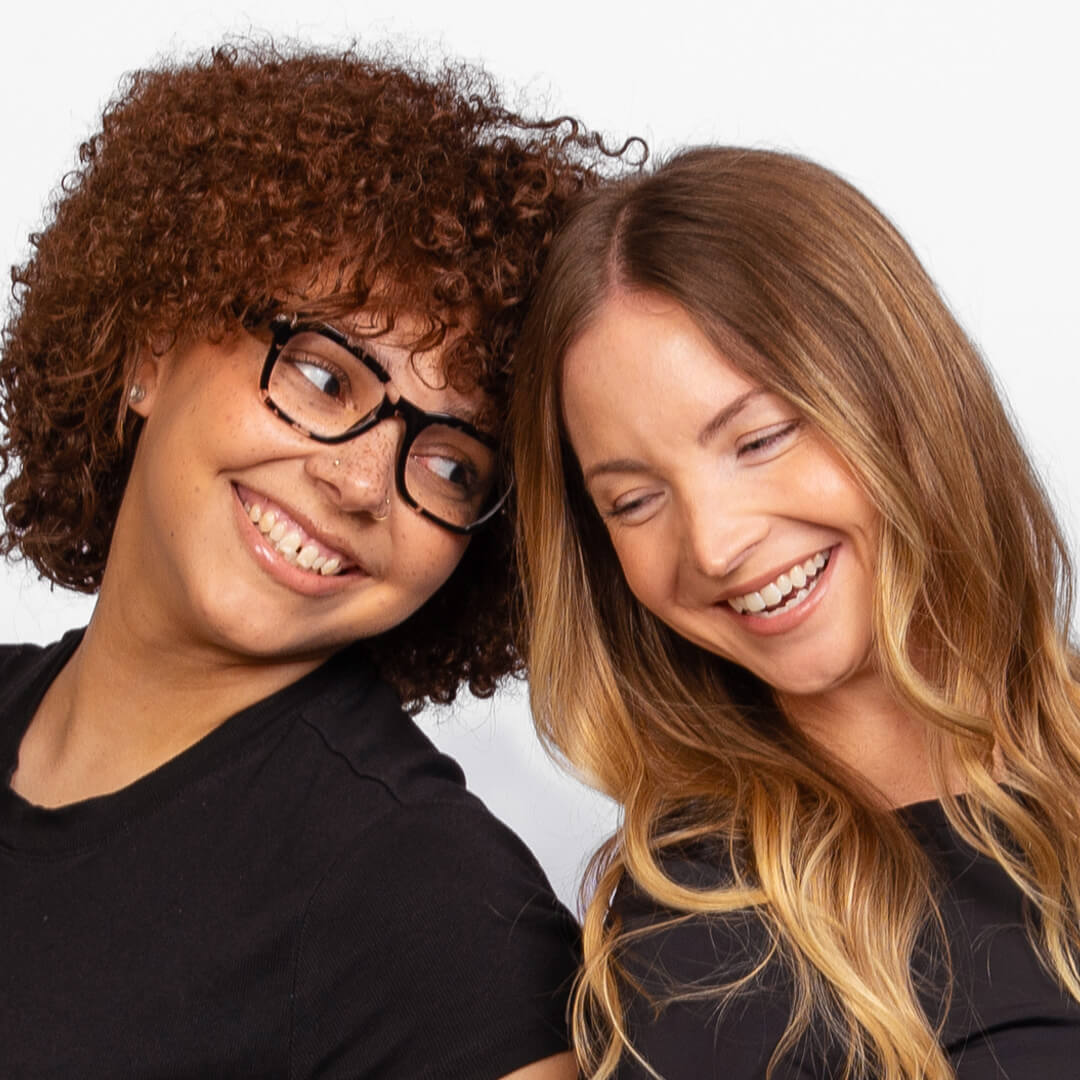 Besties posing for candid photos on a white background.