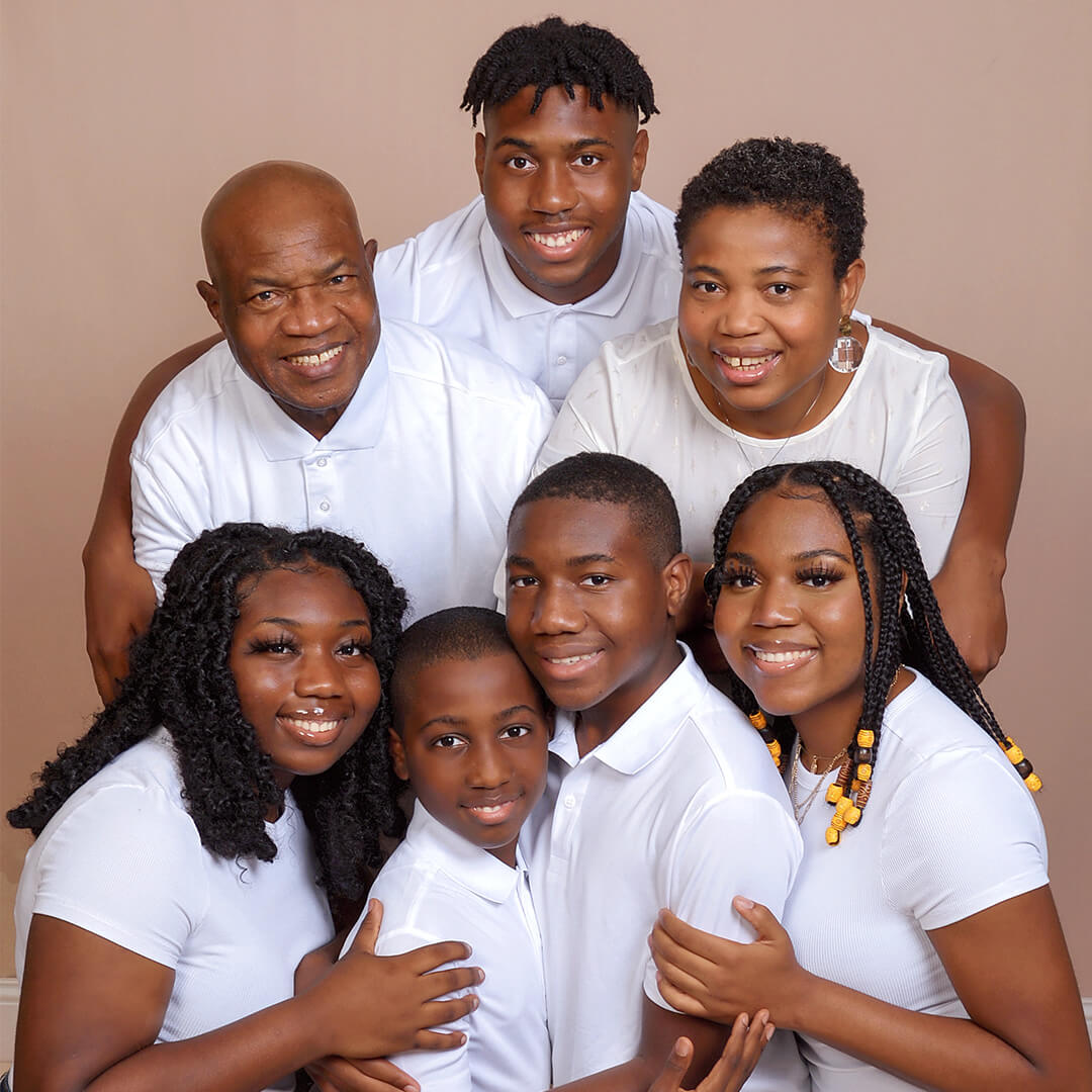 Family dressed in white shirts, capturing generation photos at JCPenney Portraits.