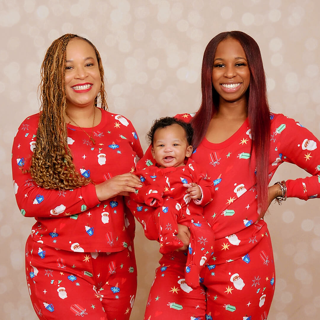 Family dressed in matching pajamas for Christmas pictures at JCPenney Portraits.