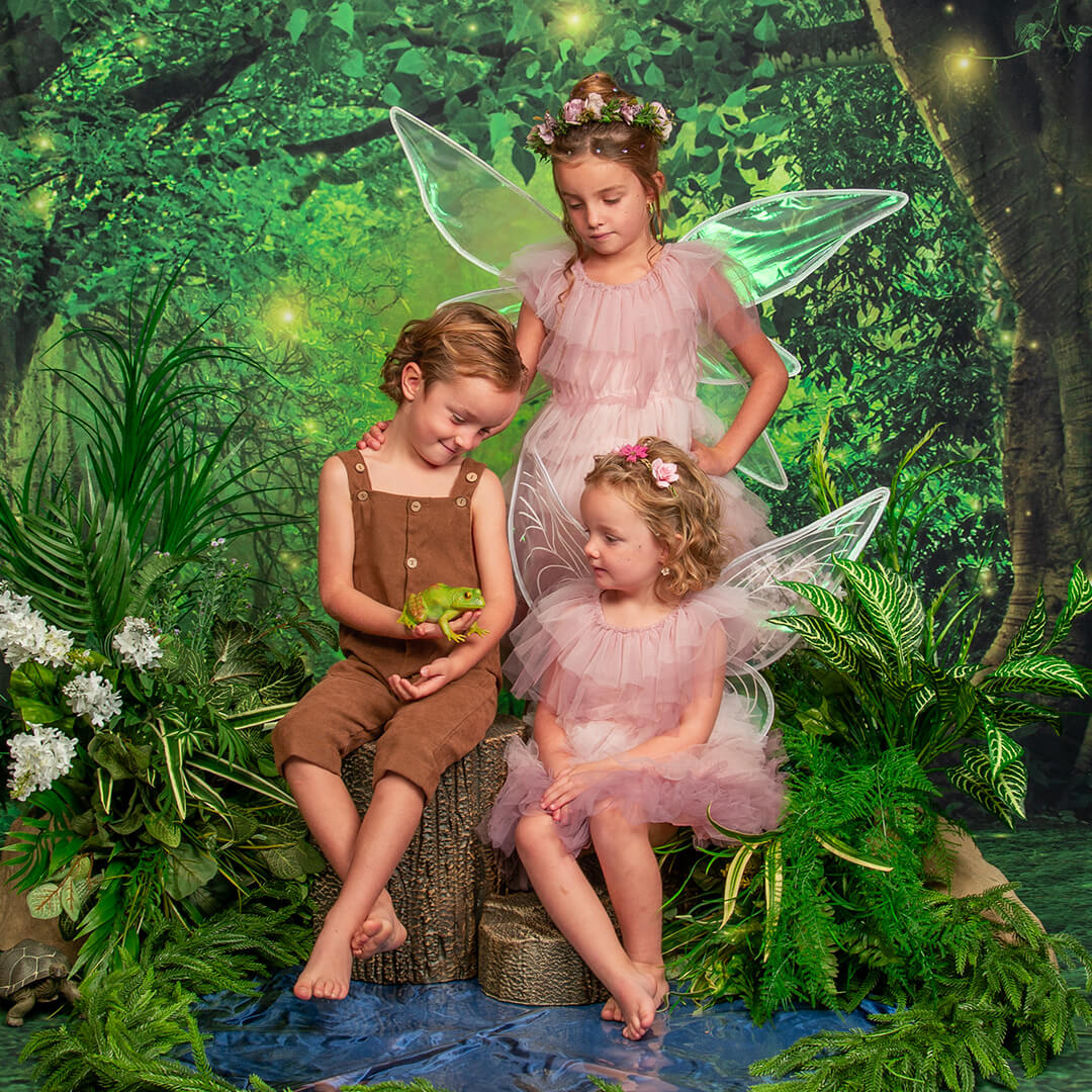 Siblings posing for fairy photos at JCPenney Portraits.