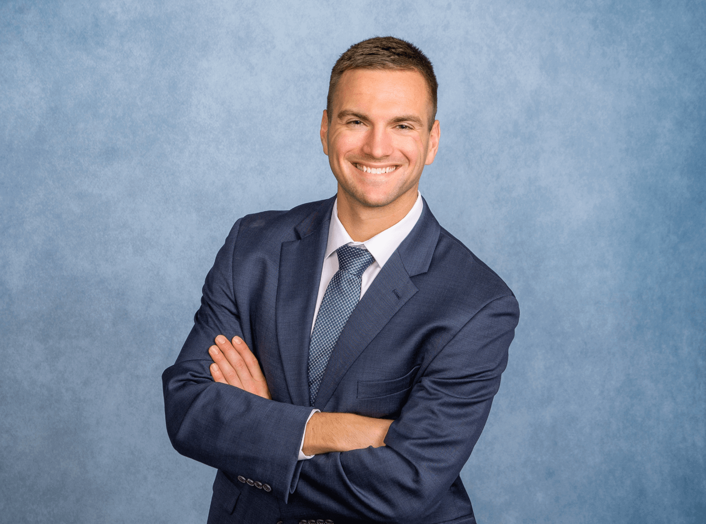 Man in a suit and tie for professional business headshots at JCPenney Portraits.