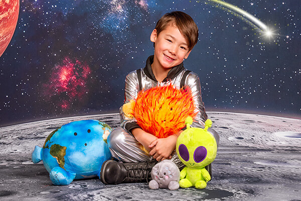 Boy holding space props for space photography.