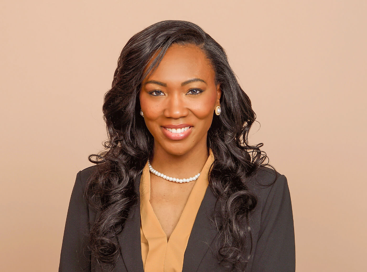 Woman in a black blazer for business headshot photography at JCPenney Portraits.