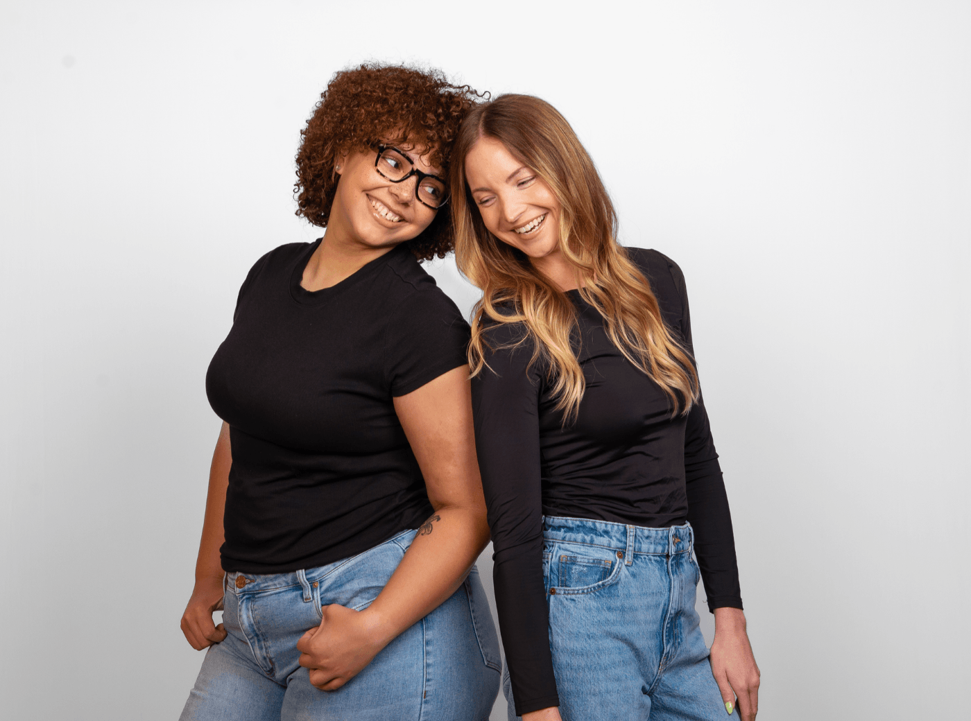 Best friends posing back to back for a best friend photoshoot at JCPenney Portraits.